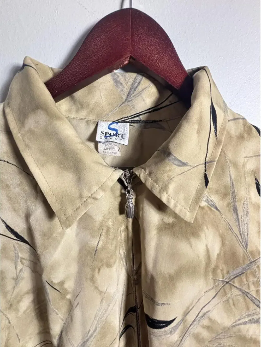 90s Sportswear Jacket with black leaf-like graphics on beige background